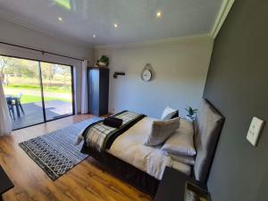 a bedroom with a bed and a sliding glass door at Toekoms Inn in Aliwal North