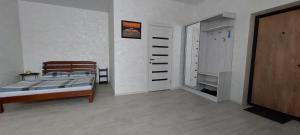 a bedroom with a bed and a closet at Уютная квартира в Одессе in Odesa