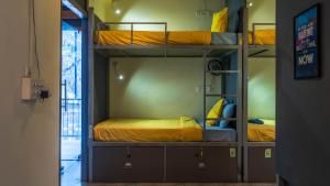 a room with two bunk beds in a room at TriboRoots Hostel in Anjuna