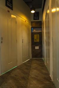 an empty hallway with white doors in a building at TriboRoots Hostel in Anjuna