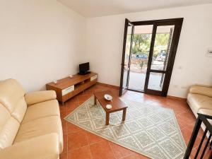 a living room with a couch and a table at Villa Pinta - Key to Villas in Codaruina