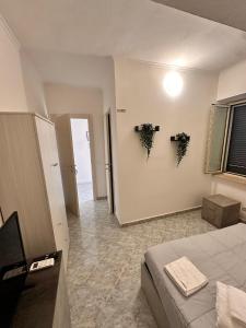 a bedroom with a bed and plants on the wall at Eden Affittacamere in Anzio