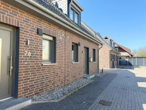 a brick building with a sidewalk next to a street at 1360- Annina 1 in Dahme