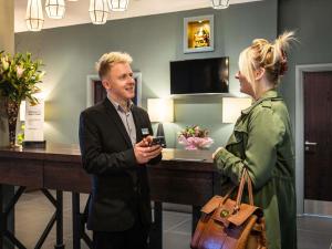 a man and a woman standing in a room at Mercure Bridgwater in Bridgwater