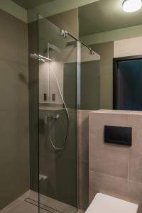 a shower with a glass door in a bathroom at Hostel Rest in Krakow