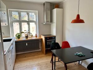 a kitchen with a table and a dining room at Ole Rømers Gade 108 in Aarhus +19 photos