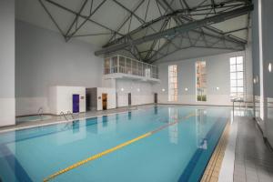 a large swimming pool with blue water at Maldron Hotel & Leisure Centre, Oranmore Galway in Oranmore