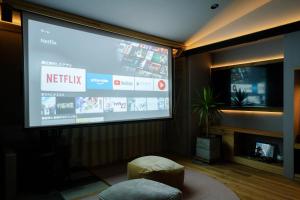 a large screen in a living room with a tv at Cellar 88 in Sonogi