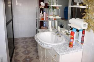 a bathroom with a sink and a shower at Rico Home Stay in Nkotunsi +61 photos