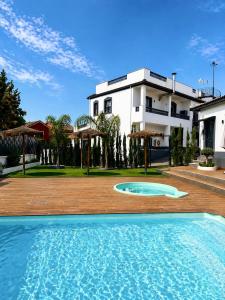 a large swimming pool in front of a building at Villas Del Acebuche in Córdoba