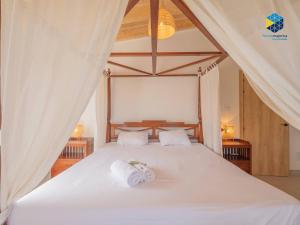 a bedroom with a white bed with two towels on it at Finca Mica in Llucmajor +88 photos