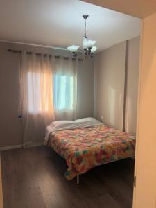 a bed in a room with a window at Valentina Cozy 2-Bedroom House in Lushnjë
