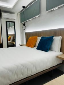 a bed with colorful pillows on it in a room at Villas Del Acebuche in Córdoba +92 photos