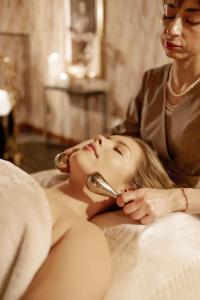a woman laying on a bed with a mirror at Dwór Prezydencki Boutique Hotel & SPA in Tarnów