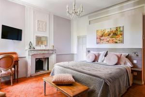a bedroom with a bed and a fireplace at Château De Jouques in Gémenos