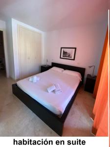 a bedroom with a bed with two pillows on it at Apartamento Cala Busquets 6 pax in Ciutadella +13 photos