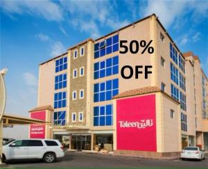 a building with a sign that says percent off at Taleen Serviced Apartments Al-Ahsa- تالين الاحساء للشقق المخدومة in Ruqaiqah