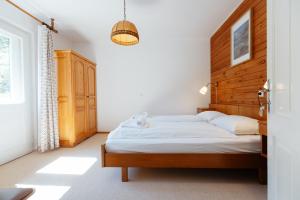 a bedroom with a bed with a wooden headboard at House Škantar Bohinj in Bohinj