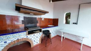 a kitchen with a brick oven and a table at Estudio Las Rotas in Denia