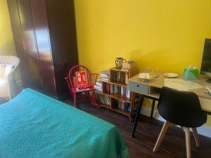 a bedroom with a bed and a desk and a deskablish at St John's Town of Dalry Glentress Apartment 1 in Dalry