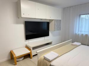 a bedroom with a bed and a flat screen tv at Apartament Faleza Nord in Constanţa