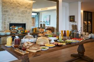 a buffet of food on a table in a room at Spanish Farm Boutique Hotel & Villas in Somerset West