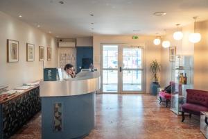 a man sitting at a counter in a restaurant at Hotel AMERIQUE in Palavas-les-Flots +71 photos