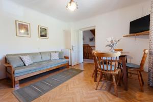 a living room with a couch and a table at House Škantar Bohinj in Bohinj