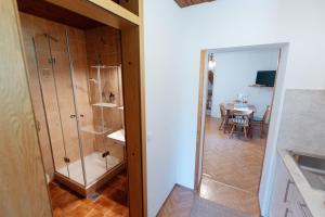 a bathroom with a shower and a dining room with a table at House Škantar Bohinj in Bohinj +31 photos