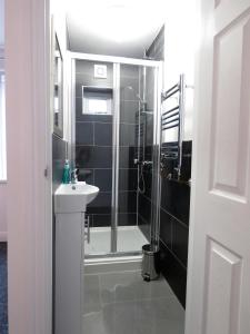 een badkamer met een douche en een wastafel bij StayNEC Moat House Birmingham - For Company, Contractor and Leisure Stays - NEC, HS2, JLR, Airport in Birmingham