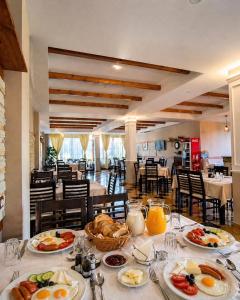 a table with plates of breakfast food on it at Hotel Villa Megi in Golem