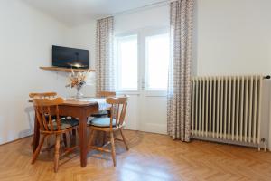a dining room with a table and chairs and a window at House Škantar Bohinj in Bohinj