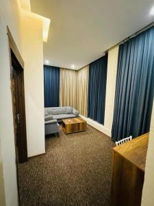 a living room with a couch and a coffee table at Koll Hotel in Erbil +20 photos