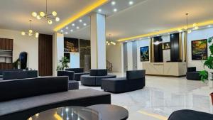 a lobby with couches and tables in a building at Koll Hotel in Erbil