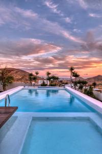 a large swimming pool with a sunset in the background at Villa El Erizo - Pool By Lanzarote Vacation Homes in Nazaret