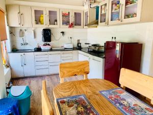 a kitchen with a table and a refrigerator at Overland Heights - Near Leh Airport in Leh +17 photos