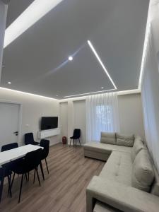 a living room with a couch and a table at Golden Stay in Pogradec