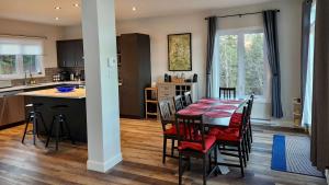 a kitchen and dining room with a table and chairs at Pool Table Private Beach - Breakfast Included - Fontainebleau in Labelle
