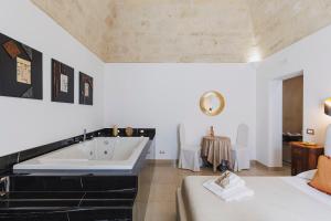 a bathroom with a large tub and a bed at Ventidue Venti in Bari