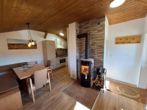 a kitchen and dining room with a wood stove at Ferienhof Mültner in Nordheim vor der Rhön