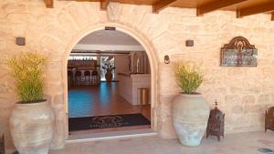 an entrance to a house with two large vases at Villa Demetra Resort in San Leone