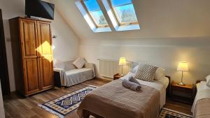 a bedroom with a bed with a pillow on it at Oberża Pod Kudłatym Aniołem in Cisna