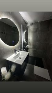 a bathroom with a sink and a mirror at Suite Dima in Vedène