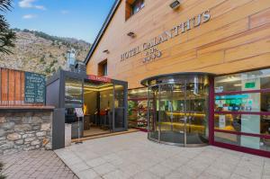 a store front of a building with a pharmacy at Wuau! Hotel Galanthus & Spa in Soldeu