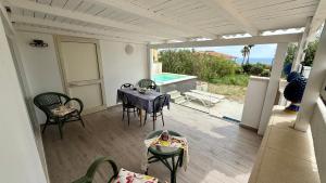 a patio with a table and chairs and a pool at Deep Sea Residence in Agrigento