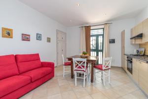 a living room with a red couch and a table at Domos Pintadas -Happy Rentals in Rudalza