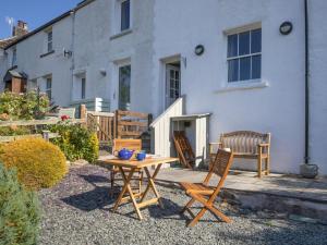a patio with a table and chairs in front of a house at 2 Bed in Keswick oc-sz082 in Threlkeld