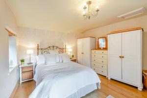 a bedroom with a large white bed and a dresser at 1 Bed in Starkholmes oc-q30994 in Matlock Bank
