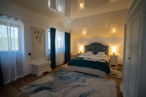a bedroom with a large bed and a large rug at Serafim's Suites Airport in Iaşi