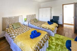 two beds in a room with blue pillows on them at 4 Bed in High Peak oc-dcchb in Chinley